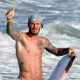 A shirtless David Beckham catches some waves in Malibu, Calif., on August 27, 2011