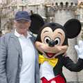 Sir Anthony Hopkins meets Mickey Mouse in front of Sleeping Beauty Castle at Disneyland park in Anaheim, Calif., on April 1, 2013