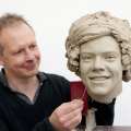 Madame Tussauds, sculptor Jim Kemp works on the clay head of Harry Styles of One Direction. Madame Tussauds announced on March 11, 2013 that the world famous wax attraction will immortalize the band by creating five individual wax figures of each member
