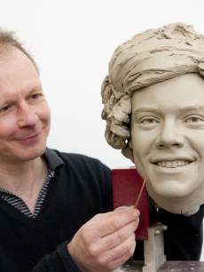 Madame Tussauds, sculptor Jim Kemp works on the clay head of Harry Styles of One Direction. Madame Tussauds announced on March 11, 2013 that the world famous wax attraction will immortalize the band by creating five individual wax figures of each member
