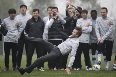 David Beckham falls during his visit to Wuhan Zall Football club on March 23, 2013 in Wuhan, Hubei Province of China