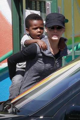 Sandra Bullock gives her son Louis a piggyback ride as she picks him up from school in Los Angeles on March 26, 2013