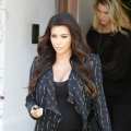 Kim Kardashian hides her pregnancy curves under a black jacket as she does some shopping in Los Angeles on April 9, 2013