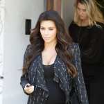 Kim Kardashian hides her pregnancy curves under a black jacket as she does some shopping in Los Angeles on April 9, 2013