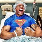 Dwayne “The Rock” Johnson shows off his guns from a hospital bed following surgery on April 22, 2013