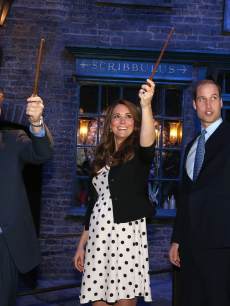 Prince Harry, Catherine, Duchess of Cambridge and Prince William, Duke of Cambridge raise their wands on the set of the Harry Potter Films during the Inauguration Of Warner Bros. Studios Leavesden on April 26, 2013 in London, England