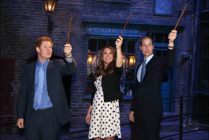 Prince Harry, Catherine, Duchess of Cambridge and Prince William, Duke of Cambridge raise their wands on the set of the Harry Potter Films during the Inauguration Of Warner Bros. Studios Leavesden on April 26, 2013 in London, England