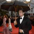 Leonardo DiCaprio holds an umbrella on May 15, 2013 as he arrives for the screening of the film ‘The Great Gatsby’ ahead of the opening of the 66th edition of the Cannes Film Festival in Cannes