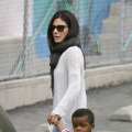 Sandra Bullock leads her son Louis into his school in Los Angeles on May 21, 2013