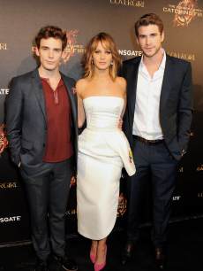 Sam Claflin, Jennifer Lawrence and Liam Hemsworth are seen at Lionsgate’s ‘The Hunger Games: Catching Fire’ Cannes Party at Baoli Beach sponsored by Covergirl on May 18, 2013 in Cannes, France