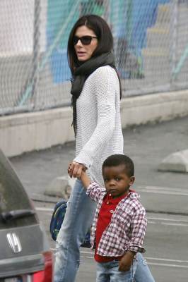 Sandra Bullock leads her son Louis into his school in Los Angeles on May 21, 2013