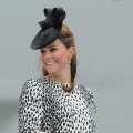 The Duchess of Cambridge smiles as she holds the scissors to cut the rope that will release a bottle to smash on the hull during a ceremony to officially name Princess Cruises’s new ship ‘Royal Princess’ in Southampton, southern England on June 13, 2013