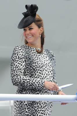 The Duchess of Cambridge smiles as she holds the scissors to cut the rope that will release a bottle to smash on the hull during a ceremony to officially name Princess Cruises’s new ship ‘Royal Princess’ in Southampton, southern England on June 13, 2013