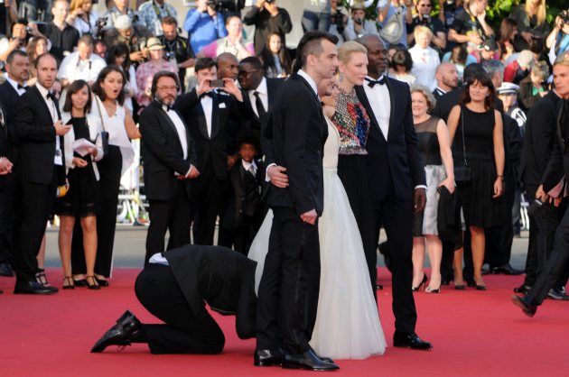 A man invades the Red Carpet as Jay Baruchel, Kit Harington, America Ferrera, Cate Blanchett and Djimon Hounsou pose at the ‘How To Train Your Dragon 2’ premiere during the 67th Annual Cannes Film Festival on May 16, 2014 in Cannes (Getty)