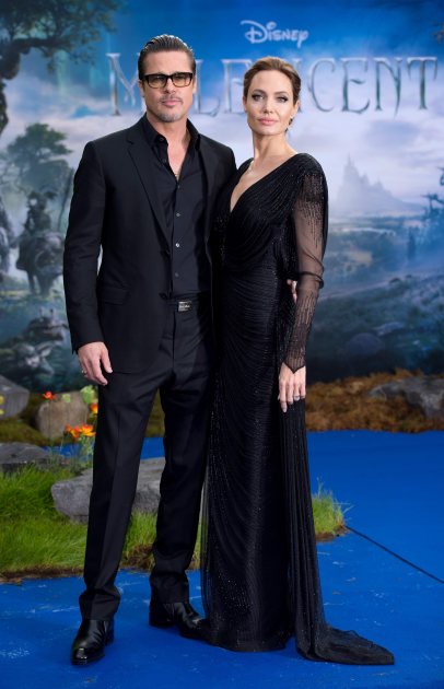 Brad Pitt and Angelina Jolie attend a private reception as costumes and props from Disney’s ‘Maleficent’ are exhibited in support of Great Ormond Street Hospital held at Kensington Palace on May 8, 2014 in London (WireImage)