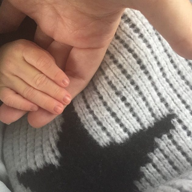 Kourtney Kardashian shared a photo of her son, Reign Aston Disick, holding her hand on December 21, 2014 (Instagram)