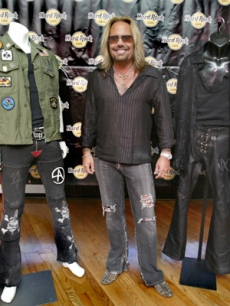 Motley Crue singer Vince Neil with two costumes from the band's last tour