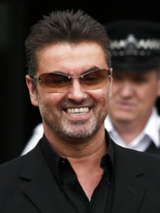 George Michael is all smiles as he leaves a London courthouse