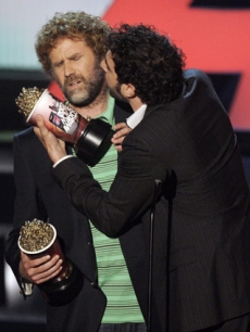 Sacha Baron Cohen gives Will Ferrell a peck on the cheek