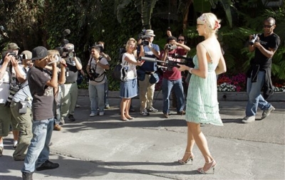 A Paris Hilton look-a-like poses outside her home
