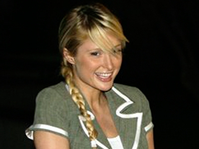 Paris Hilton smiles as she leaves jail
