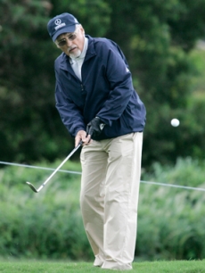 Dennis Hopper carefully studies his shot at the tourney