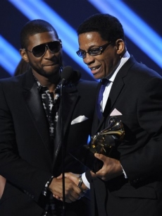 Album of the Year winner Herbie Hancock gets a handshake from Usher onstage
