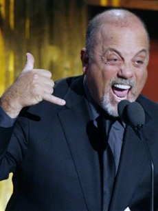 Billy Joel speaks before inducting John Mellencamp into the Rock and Roll Hall of Fame