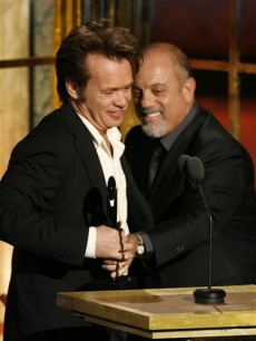 John Mellencamp accepts his award from Billy Joel