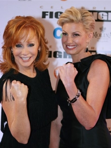 Reba McEntire and Faith Hill pose on the Fight Night red carpet