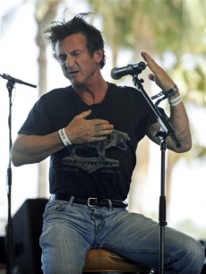 Sean Penn busts a dance move as he addresses the crowd during the third day of Coachella
