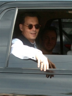 Johnny Depp rides to a scene of his upcoming movie ‘Public Enemies’