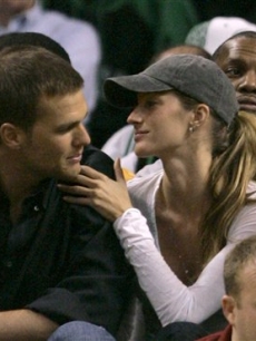 Gisele gives boyfriend Tom Brady a loving touch at a basketball game 