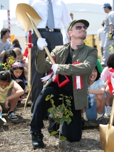 Bono plants a tree at a ‘Green Island’ event in Tokyo, Japan