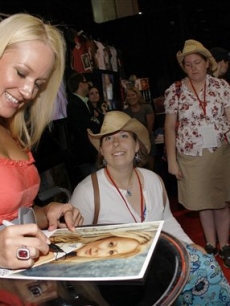 Jewel signs autographs for fans at the CMA Music Festival 