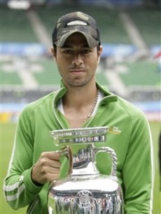 Enrique Iglesias poses with the Euro 2008 trophy in the Ernst Happel Stadium in Vienna, Austria