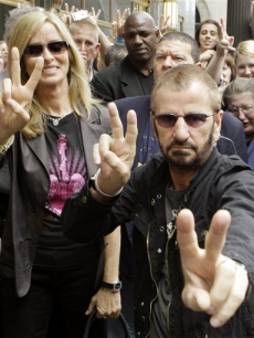 Former Beatles drummer Ringo Starr, flashes peace signs with his wife Barbara Bach, during his 68th birthday celebration