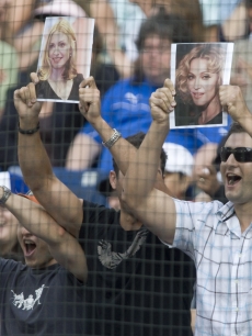 Fans hold up pictures of Madonna as Alex Rodriguez strikes out in Canada 