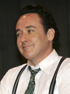 John Cusack grins at a press conference for his movie “Shanghia” in Bangkok, Thailand