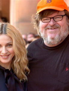 Madonna poses with Michael Moore at the screening of her documentary, “I Am Because We Are”