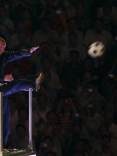David Beckham kicks a ball during the closing ceremony for the 2008 Beijing Olympics