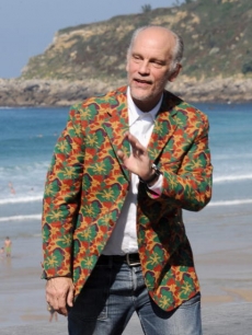 The colorful John Malkovich waves hello from the San Sebastian Film Festival