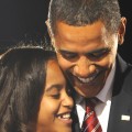 Barack Obama hugs his oldest daughter Malia following his victory 