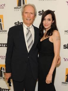 Clint Eastwood and Angelina Jolie pose backstage at the 12th Annual Hollywood Film Festival Awards Gala at the Beverly Hilton Hotel