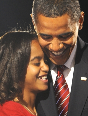 Barack Obama hugs his oldest daughter Malia following his victory 