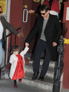 Suri leads her dad, Tom Cruise, out of a restaurant in NYC, Nov. 28, 2008 