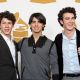 Nick Jonas, Joe Jonas, and Kevin Jonas of The Jonas Brothers pose in the press room during the Grammy Nominations concert