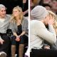 Jake Gyllenhaal plants a kiss on girlfriend Reese Witherspoon at the Lakers’ game