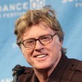Robert Redford smiles for the press during Sundance’s opening day