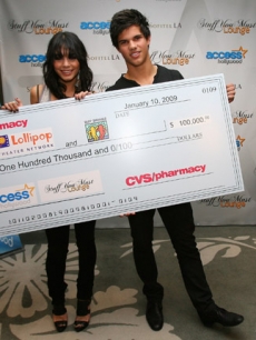 Vanessa Hudgens and Taylor Lautner present the CVS:Pharmacy donation to the Lollipop Theater Network and Best Buddies at Access’ Stuff You Must lounge
